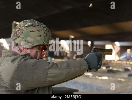U.S. Air Force Col. Joshua W. Petry, long range planning director for Special Operations Command Korea, fires the M17 pistol on Camp Humphreys, Republic of Korea, Feb. 23, 2022. 3-2 GSAB ran the pistol qualification range for their soldiers and members of the Special Operations Command Korea to ensure they met training requirements. Stock Photo
