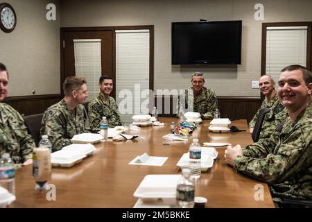 Rear Adm. Pete Garvin, commander, Naval Education and Training Command (NETC), dines with Officer Candidate School (OCS) graduates at Officer Training Command, Newport (OTCN), Rhode Island, Feb. 23. OTCN offers four officer training programs at Naval Station Newport, including Officer Candidate School, Officer Development School, the Limited Duty Officer and Chief Warrant Officer Academy, and the Naval Science Institute. OTCN morally, mentally and physically develops these future leaders of character and competence - imbuing them with the highest ideals of honor, courage and commitment in orde Stock Photo