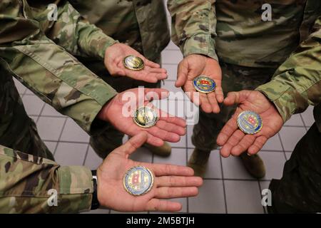 Citizen-Soldiers show the coin of excllence received from Maj. Gen. John C. Andonie, deputy director of the Army National Guard, at the Luis Muñoz Marín International Airport in Carolina at Fort Buchanan, Puerto Rico, Feb. 24, 2022. The deputy director of the Army National Guard visited the island to learn about the Puerto Rico National Guard's COVID-19 operations. Stock Photo