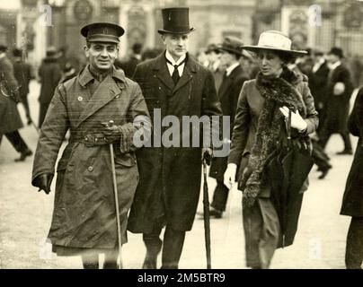 Dr. Varaztad H. Kazanjian leaving Buckingham Palace in 1919 after his investiture as a Companion of St. Michael and St. George for his services during World War I. With him are his friends, Mr. and Mrs. W. Warwick James of London. Dr. Kazanjian was an Armenian American oral surgeon who pioneered techniques for plastic surgery and is considered to be the founder of the modern practice of plastic surgery Stock Photo
