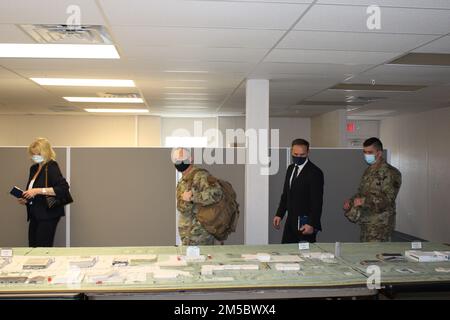 Visitors from the United Kingdom’s Defence Infrastructure Organization take a look at the tabletop model of the Installation of the Future at AFCEC’s Natural Disaster Recovery Division, Tyndall Air Force Base, Florida. Stock Photo