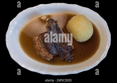 Schaeuferle with dumpling on black background, Bavaria, Germany Stock Photo