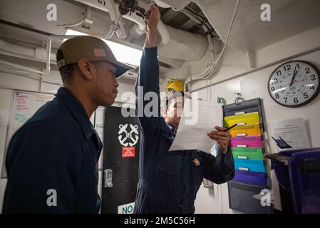 220224-N-XB010-1001 PACIFIC OCEAN (Feb. 24, 2022) Damage Controlman 3rd Class Emerson Ovando, from San Fernando Valley, Calif., right, and Hull Maintenance Technician Fireman Apprentice Jaymes Mikell, from Savannah, Ga., secure a valve during a general quarters drill aboard USS New Orleans (LPD 18). New Orleans, part of the America Amphibious Ready Group, is operating in the U.S. 7th Fleet area of responsibility to enhance interoperability with allies and partners and serve as a ready response force to defend peace and stability in the Indo-Pacific region. Stock Photo