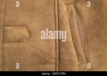 Leather suede jacket, pocket stitches details, abstract backdrop, close up Stock Photo