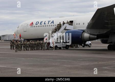 U.S. Army service members assigned to the 1st Armored Brigade Combat Team, 3rd Infantry Division, deploy to the U.S. Army Europe and Africa area of operations, from Hunter Army Airfield, Georgia, Feb. 28, 2022. The 3rd ID Soldiers deploying represent the U.S. commitment to uphold the principles of democracy, territorial integrity, sovereignty and respect for the international rules-based order. Stock Photo