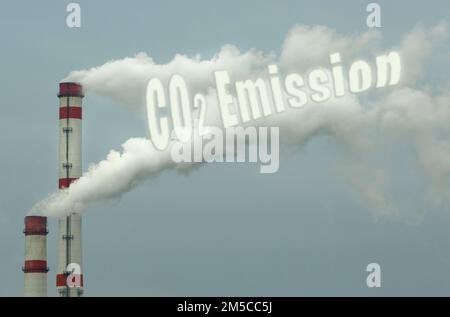 Ecological concept. From the pipe of an industrial enterprise comes smoke with the inscription - CO2 Emission, which pollutes the air. Stock Photo