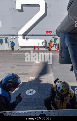 Sailors fuel an MH-60S Sea Hawk helicopter aboard the guided-missile ...