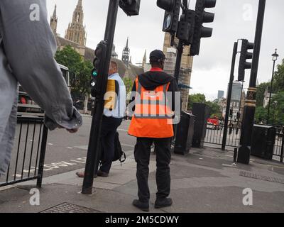 LONDON, UK - CIRCA OCTOBER 2022: Royal Mail postman delivering mail in central London Stock Photo