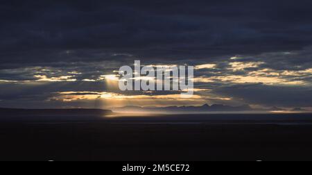 Sun shining through heavy clouds landscape photo Stock Photo