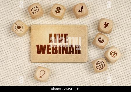 Business concept. On the fabric there are cubes with drawings and a sign with the inscription - Live Webinar Stock Photo