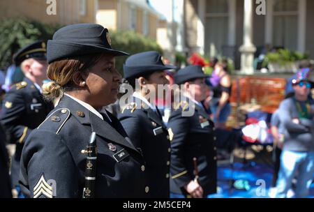 Sgt. Rashada Smith, a clarinet player with the 313th Army Band out of Huntsville, Alabama, stands with fellow band members during the Rex Parade on Mar 1, 2022, in New Orleans, Louisiana. The Rex Parade, or the Rex Procession has been the highlight of Mardi Gras day since the Rex Organization was formed and first paraded in 1872. The bands participating in this event not only displays the talent of the soldiers but can also be used as a recruitment tool and build relations with the local community. (Army Reserve image by Staff Sgt. Rodney Roldan). Stock Photo