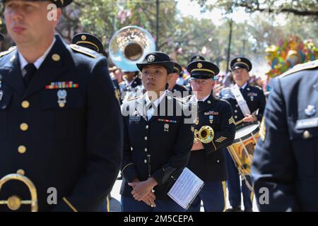 U.S. Army Reserve soldiers from the 313th Army Band out of Huntsville, Alabama, participate in the Rex parade on Mar 1, 2022, in New Orleans, Louisiana. The bands performance not only displays the talent of the soldiers but can also be used as a recruitment tool and build relations with the local community. (Army Reserve image by Staff Sgt. Rodney Roldan). Stock Photo