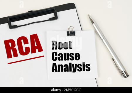 Business concept. On the tablet is a sheet of paper with the inscription - RCA and stickers with the inscription - Root Cause Analysis, next to the pe Stock Photo