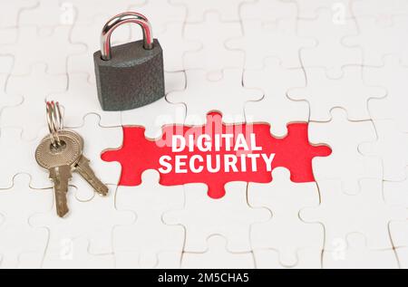 Business and security concept. On puzzles there is a lock and keys, on a red surface there is an inscription - digital security Stock Photo