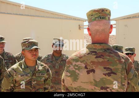 Pfc. Martinez and Cpl. Broomer listen to Stewart speak. Brig. Gen. Stewart is the Commander of the 32nd Army Air and Missile Defense Command. He visited Soldiers from Bravo Battery, 1-44 Air Defense Artillery while conducting battlefield circulation. Stock Photo