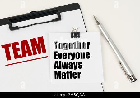 Business concept. On the tablet is a sheet of paper with the inscription - TEAM and stickers with the inscription - Together Everyone Always Matter, n Stock Photo