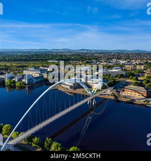 Aerial view of the Infinity Bridge spanning the river Tees located in Stockton on tees, North East England with the Cleveland Hills in the background Stock Photo
