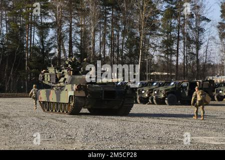 U.S. Soldiers assigned to 1st Armored Brigade Combat Team, 3rd Infantry Division prepare to go to the range after receiving assigned M1A2 Abrams tank from Army Prepositioned Stocks Program in the Grafenwoehr Training Area, Germany, March 2, 2022. Army Prepositioned Stocks is a U.S. Department of the Army program in which equipment sets are stored around the globe for use when a combatant commander requires additional capabilities. The U.S. Army has seven APS regions and APS-2 is designated for Europe. APS sites reduce deployment timelines, improve deterrence capabilities, and provide additiona Stock Photo