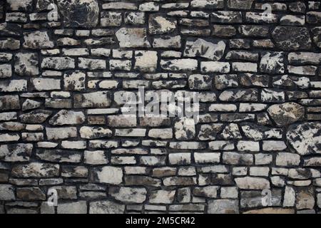 Very old gray natural limestone with dark color as a background for graphical designs Stock Photo