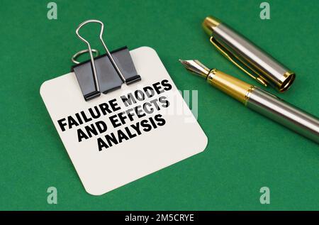 Business and industry concept. On a green surface, a pen and a sheet of paper with the inscription - Failure Modes and Effects Analysis Stock Photo