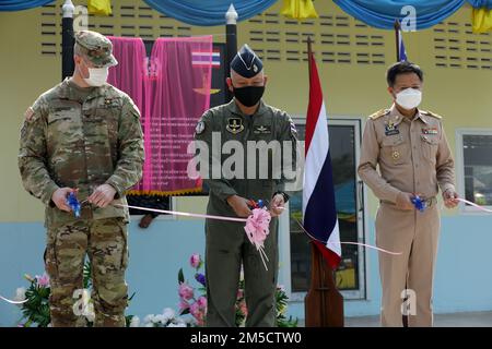 U.S. Army Col. Eric Dennis (left), Royal Thai Air Force Group Capt. Nattavat Duangsungnaen (Center), and Deputy Governor of Saraburi Province Akeporn Juisomrad (right) cut the ribbon during the dedication ceremony of Ban Nong Makha school as part of Cobra Gold 2022 in the Saraburi Province of the Kingdom of Thailand, March 3, 2022. CG 22 is the 41st iteration of the international training exercise that supports readiness and emphasizes coordination on civic action, humanitarian assistance, and disaster relief. From Feb. 22 through March 4, 2022, this annual event taking place at various locati Stock Photo