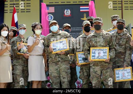 Members of the 374th Civil Engineer Squadron, 374th Mission Support Group, celebrate with Ban Nong Makha school members for the school dedication ceremony as part of Cobra Gold 2022 in the Saraburi Province of the Kingdom of Thailand, March 3, 2022. CG 22 is the 41st iteration of the international training exercise that supports readiness and emphasizes coordination on civic action, humanitarian assistance, and disaster relief. From Feb. 22 through March 4, 2022, this annual event taking place at various locations throughout the Kingdom of Thailand increases the capability, capacity, and inter Stock Photo