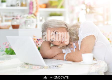old nice woman using laptop at home Stock Photo
