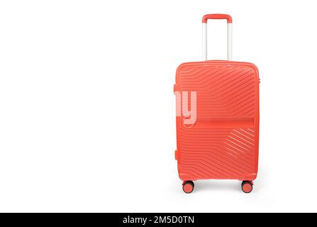 Suitcase isolated on white. Red, fashionable travel suitcase on white background with shadow. Red travel luggage Stock Photo