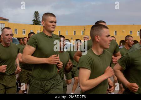 The new U.S. Marines with Bravo Company, 1st Recruit Training Battalion, conduct a motivational run at Marine Corps Recruit Depot San Diego, Mar. 3, 2022. This is the first time the new Marines were able to see their families since they began their training 13 weeks ago. Stock Photo