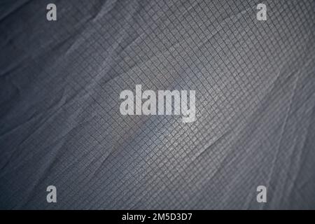 Abstract modern mesh material texture for unusual backdrop. Light weight wrinkled seamless pattern of pale gray plaid fabric for wallpaper or art ideas. Concept of textures and background. Stock Photo