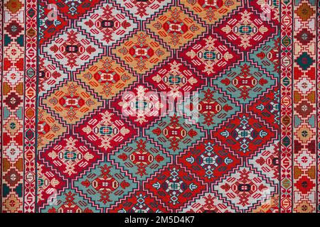 Carpet Texture, Abstract Ornament. Colorful Oriental Mosaic Carpet With Traditional Ornament. Patterned Carpet. Closeup View Of Handmade Woven Carpet Stock Photo