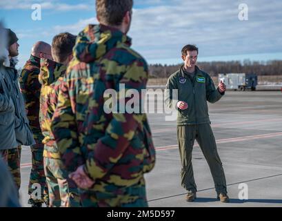 A U.S. Air Force pilot, right, assigned to the 48th Fighter Wing from Royal Air Force Lakenheath discusses F-35 Lightning II aircraft capabilities with members of the Belgian air force at Ämari Air Base, Estonia, March 3, 2022. Members of the 48th FW and three F-35s forward deployed to Ämari AB to support NATO’s collective defense and enhanced Air Policing mission. The Belgian and U.S. Air Forces have flown, and continue to fly, together to protect and defend allied airspace. Stock Photo