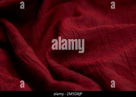 Blur, red fabric background. Red cloth waves background texture. Red fabric cloth textile material. Stock Photo