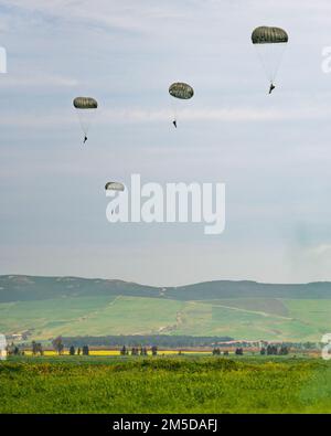 U.S. Army paratroopers assigned to 1st Squadron, 91st Cavalry Regiment (Airborne) descend to the ground using MC-6 parachutes during an airborne operation alongside soldiers from the Tunisian Special Forces Group near Bizerte, Tunisia on March 3, 2022.    The 173rd Airborne Brigade is the U.S. Army's Contingency Response Force in Europe, providing rapidly deployable forces to the United States European, African, and Central Command areas of responsibility. Forward deployed across Italy and Germany, the brigade routinely trains alongside NATO allies and partners to build partnerships and streng Stock Photo