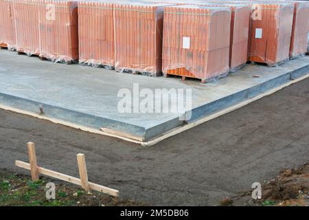 Hollow perforated bricks stand on the floor slab for a own home Stock Photo