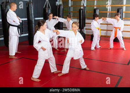 School girls practicing new karate moves in pairs Stock Photo