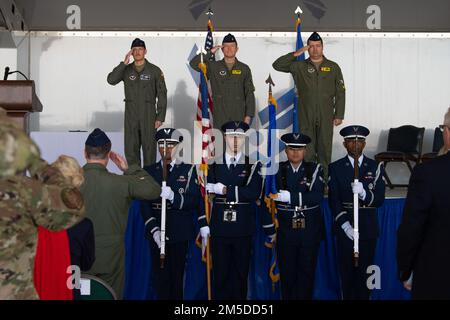 U.S. Air Force Airmen salute the American Flag during the National Anthem March 4, 2022, at Moody Air Force Base, Georgia. Moody Honor Guard members ‘Present the Colors’ before every change of command ceremony. Stock Photo
