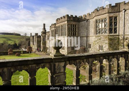 Haddon Hall, near Bakewell in Derbyshire, England . A view of the south side of the hall and gardens with a stone ballustrade in the foregroung Stock Photo