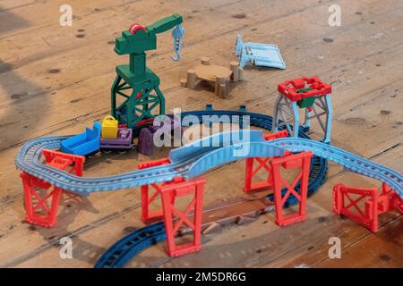 Thomas the Tank Engine plastic toy rail track train track with crane visible Stock Photo