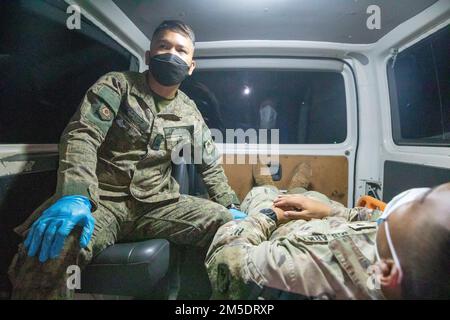 Philippine Army Staff Sgt. Richard M. Esconde, a medic aidman with Fort Magsaysay Station Hospital, 7th Infantry Regiment, transports a U.S. Soldier 'simulated casualty' to a local hospital as part of a ground evacuation drill on Fort Magsaysay, Nueva Ecija, Philippines, March 5, 2022. Salaknib is an annual Philippine Army-led, U.S. Army Pacific sponsored bilateral exercise designed to enhance U.S. and Philippine Army capacity and interoperability across the spectrum of military operations, while also strengthening the ties between the two longstanding partner nations. Stock Photo