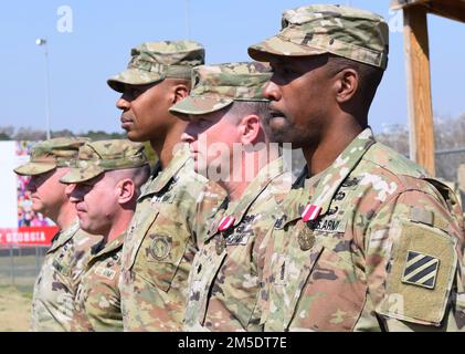 Left to Right: Lt. Col. Joshua Patterson and Master Sgt. Daniel Paul, incoming command team of the 2nd Battalion 121st Infantry Battalion; Col. Jason Baker, commander of the 48th Infantry Brigade Combat Team; Lt. Col. John Avera and Command Sgt. Maj. Rickey Gulley, outgoing command team of 2-121 prepare to conduct a change of command ceremony in Forsyth, Ga. March 5, 2022. Stock Photo