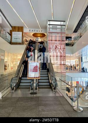 New York, NY, USA - Dec 24, 2022: People riding the escalator at World Trade Center 4 Stock Photo