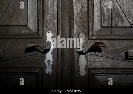 Marktl, Germany. 28th Dec, 2022. The handles on the wooden door of the house where Pope Benedict XVI was born. Pope Emeritus Benedict XVI is 'very ill,' according to his successor Francis. Credit: Lennart Preiss/dpa/Alamy Live News Stock Photo