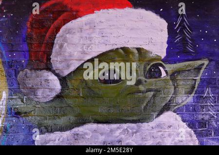 A close up of a Christmas Star Wars mural in Leeds featuring Yoda in a Santa hat. Created by artist Laffiti & Northern Mural Co Stock Photo