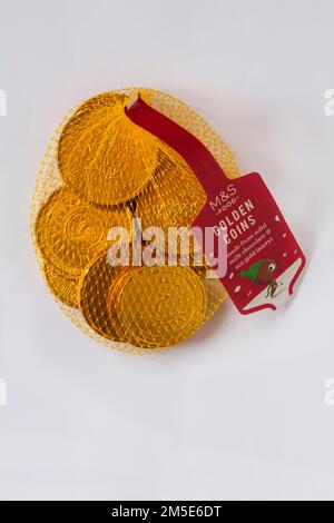 M&S Golden Coins in netting net made from solid milk chocolate & not gold (sorry) isolated on white background Stock Photo