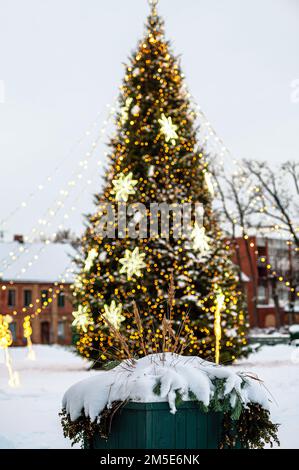 Defocused Christmas tree decorated with lights and decorations, shallow depth of field Stock Photo