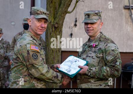 Sgt. Maj. Robert S. Wilson, outgoing 1st Infantry Division Forward Sergeant Major, receives the Meritorious Service Medal by Maj. Gen. Douglas A. Sims II, commanding general of the 1st Infantry Division and Fort Riley at Poznan, Poland, March 7, 2022. The Meritorious Service Medal is awarded to any member of the armed forces of the United States who distinguish themselves by either outstanding achievement or meritorious service to the United States. Stock Photo