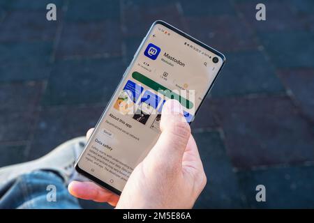 December 3, 2022, Alanya, Turkey: phone screen and Mastodon app. Man downloads application on phone Stock Photo