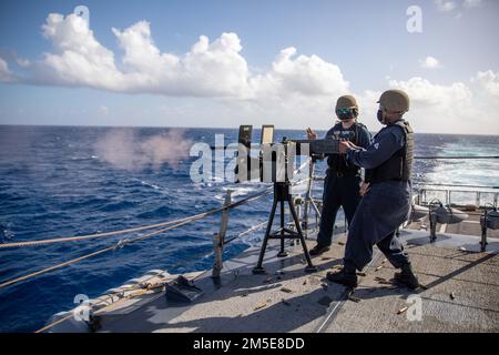 220307-N-HD110-1067  CARIBBEAN SEA - (March 7, 2022) -- Gunner’s Mate 1st Class Howard Bullock observes Senior Chief Boatswain’s Mate Kenderick Miller fire a .50-caliber machine gun during a gun shoot aboard the Freedom-variant littoral combat ship USS Milwaukee (LCS 5), March 7, 2022. Milwaukee is deployed to the U.S. 4th Fleet area of operations to support Joint Interagency Task Force South’s mission, which includes counter-illicit drug trafficking missions in the Caribbean and Eastern Pacific. Stock Photo