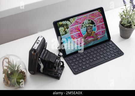 tablet, photo camera on an office desk Stock Photo